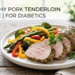A plain dish of grilled pork tenderloin slices showcasing a seasoned crust and a juicy pink center.