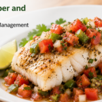 A plain dish of baked white cod fillets topped with vibrant green and red bell pepper strips and thick chunky salsa.